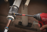 Person using a Milwaukee drill and bit holder on pipes