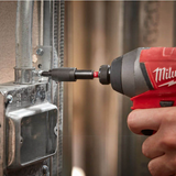 Person using a Milwaukee drill to tighten a screw into metal framing using a magnetic bit holder with Milwaukee logo