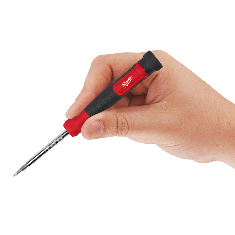 Hand holding a screwdriver with a red handle on a white background