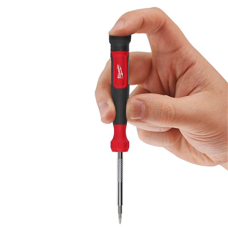 Hand holding a red and black Milwaukee screwdriver with a white background
