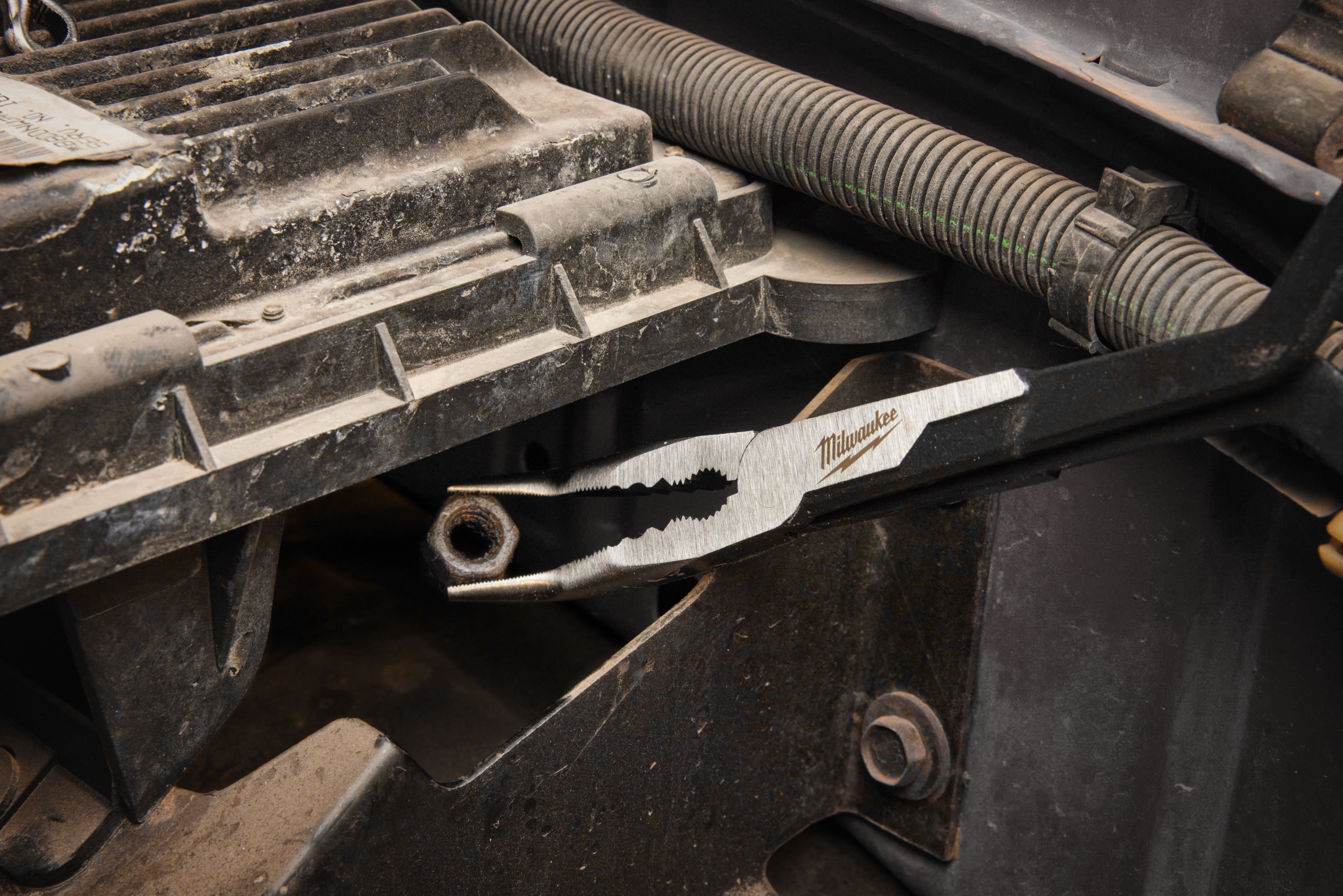 Milwaukee tool on a mechanical surface with visible branding