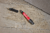 Black and red tool on a concrete surface