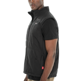 Man wearing a black vest over a black shirt