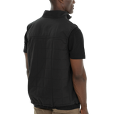 Person wearing a black vest over a black shirt