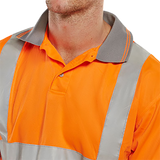 High visibility orange polo shirt close up of collar with reflective stripes worn by a person on a white background